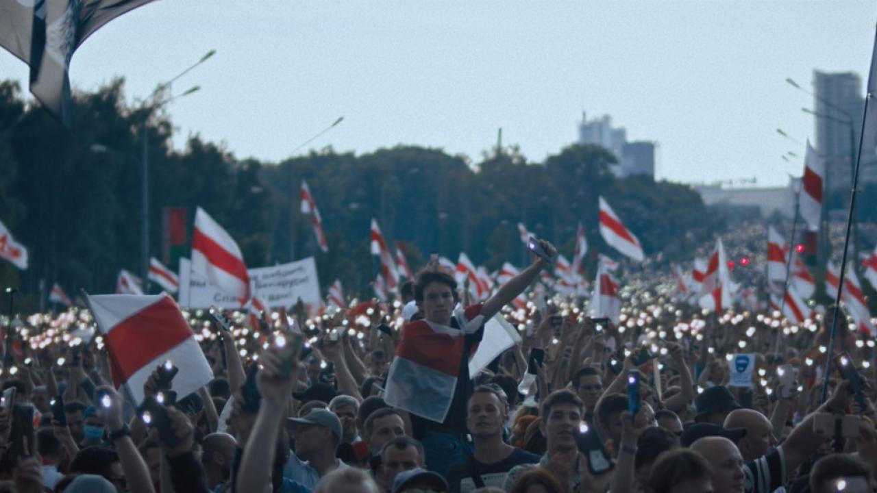 Demonstrierende vor dem Präsidentenpalast am 30.08.2020 in Minsk. Es sind sehr viele Menschen, viele tragen weiss-rote Flaggen. Die Lichter der Handys leuchten. 